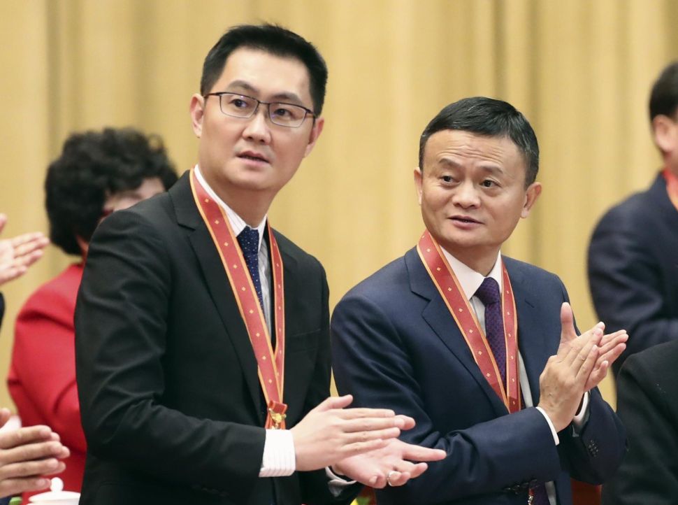 Alibaba founder Jack Ma (R) and Tencent founder Pony Ma at the 40th Anniversary ceremony of "Reform and Opening Up" on December 18, 2018 in Beijing.