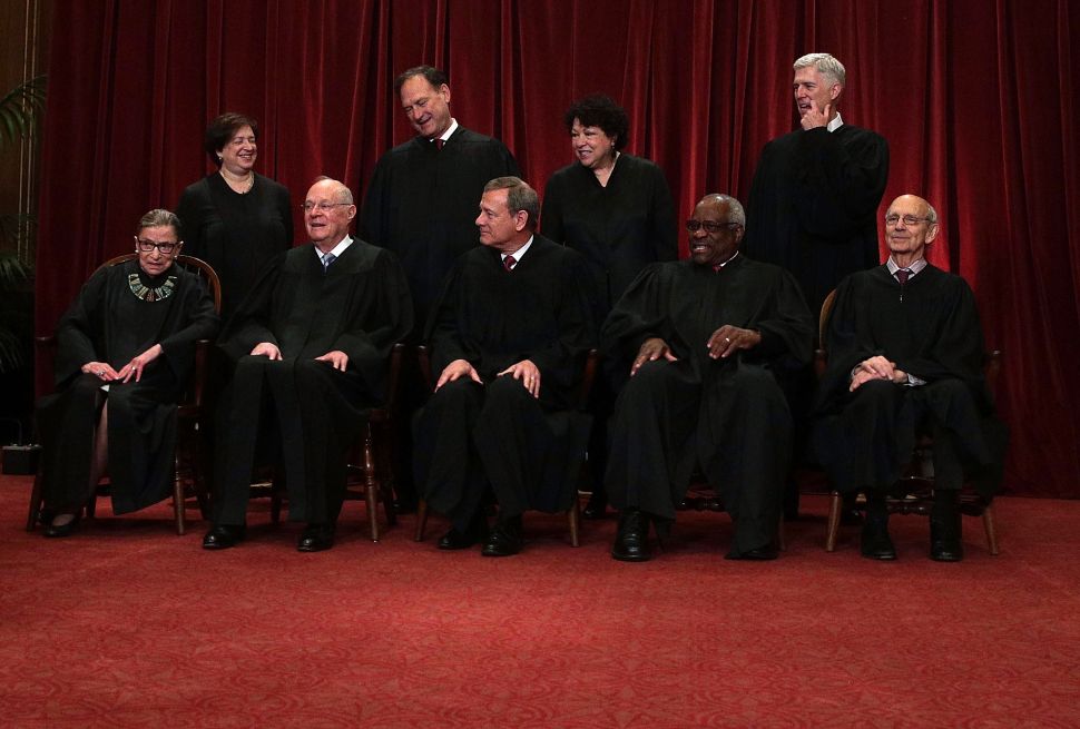 Front row from left, U.S. Supreme Court Associate Justice Ruth Bader Ginsburg, Former Associate Justice Anthony M. Kennedy, Chief Justice John G. Roberts, Associate Justice Clarence Thomas, and Associate Justice Stephen Breyer, back row from left, Associate Justice Elena Kagan, Associate Justice Samuel Alito Jr., Associate Justice Sonia Sotomayor, and Associate Justice Neil Gorsuch pose for a group portrait in the East Conference Room of the Supreme Court June 1, 2017 in Washington, DC. 