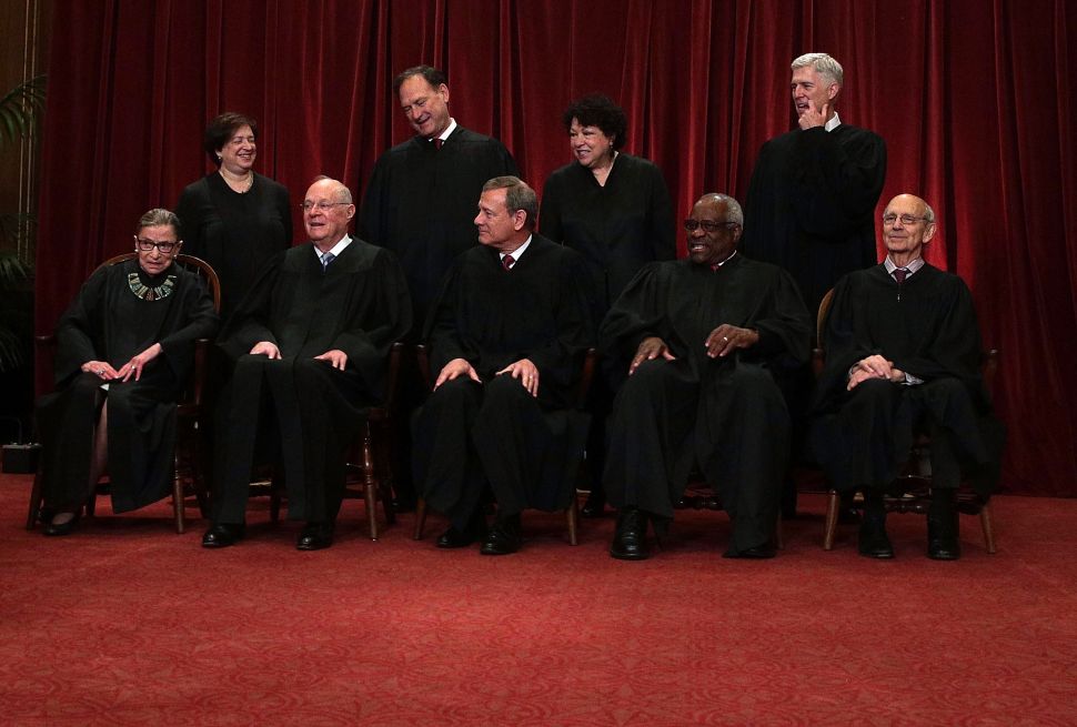 Front row from left, U.S. Supreme Court Associate Justice Ruth Bader Ginsburg, Former Associate Justice Anthony M. Kennedy, Chief Justice John G. Roberts, Associate Justice Clarence Thomas, and Associate Justice Stephen Breyer, back row from left, Associate Justice Elena Kagan, Associate Justice Samuel Alito Jr., Associate Justice Sonia Sotomayor, and Associate Justice Neil Gorsuch pose for a group portrait in the East Conference Room of the Supreme Court June 1, 2017 in Washington, DC.