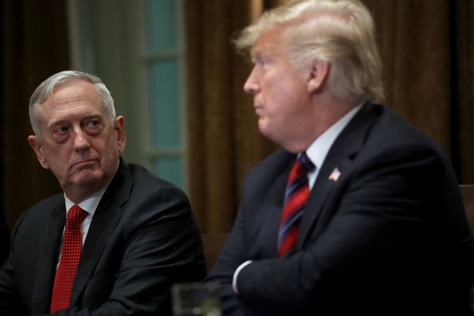 Defense Secretary Jim Mattis listens as President Donald Trump answers questions during a meeting with military leaders.