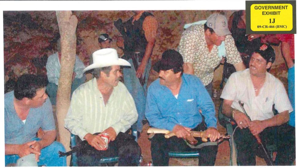 El Chapo (center in the black hat) is pictured in government evidence holding a golden AK-47.