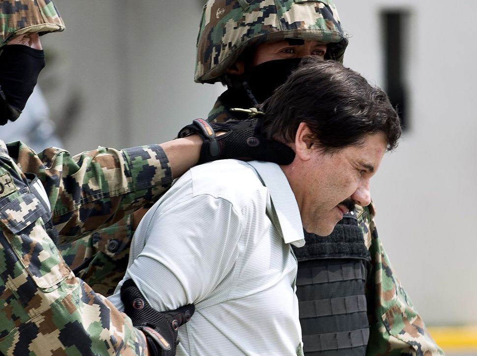El Chapo Guzman is escorted by Marines as he is presented to the press on February 22, 2014 in Mexico City. 