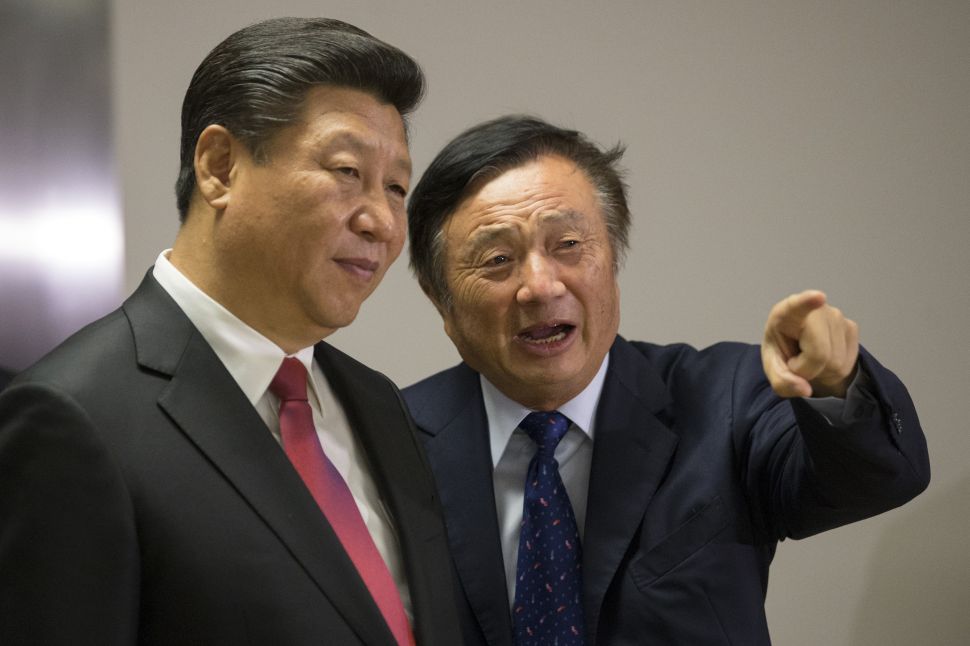 Ren Zhengfei shows Chinese President Xi Jinping around Huawei's London office during his state visit on October 21, 2015.