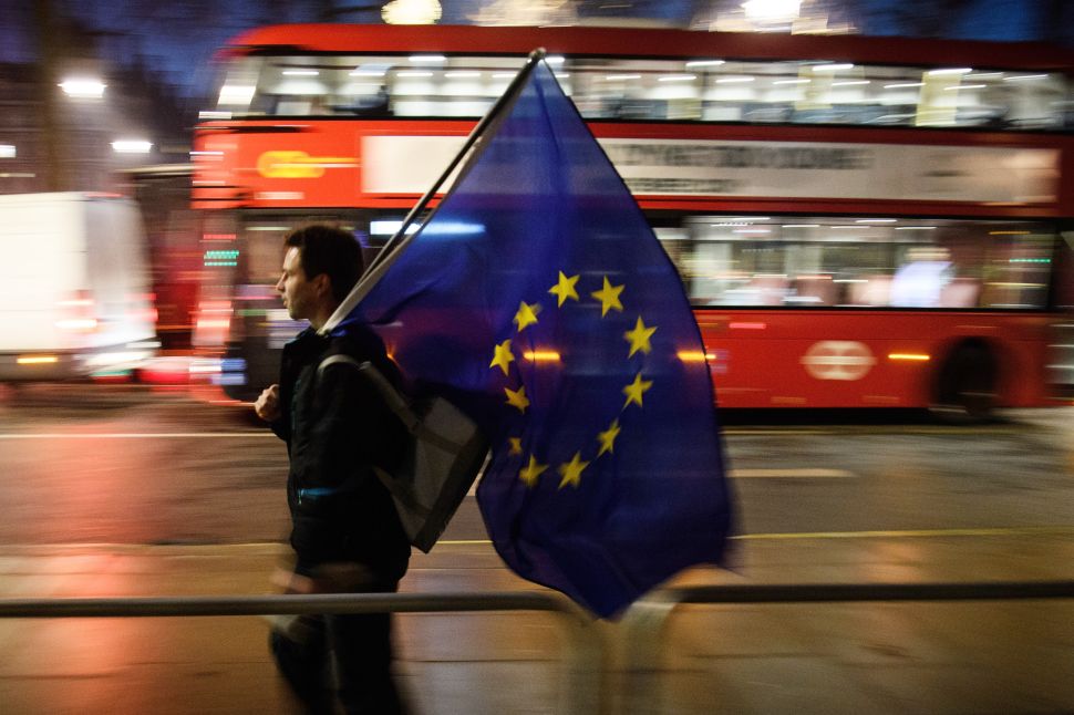 A man carries a European Union flag outside the Supreme Court in Parliament Square ahead of the ruling on whether Parliament have the power to begin the Brexit process, on January 24, 2017 in London, England.