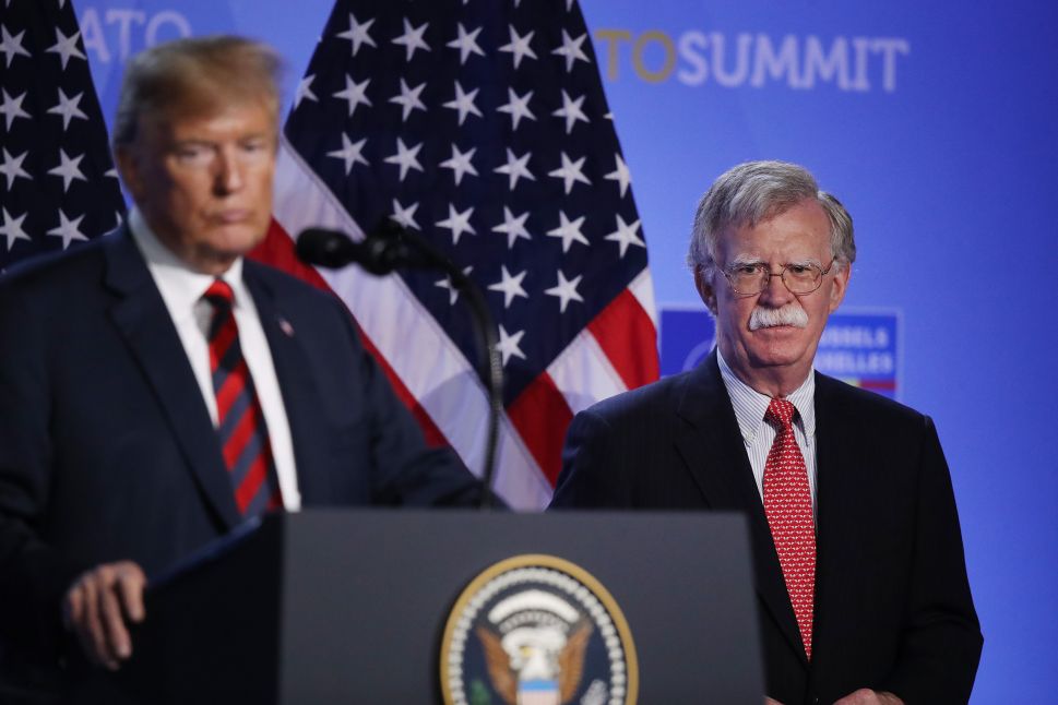 President Donald Trump, flanked by National Security Advisor John Bolton.