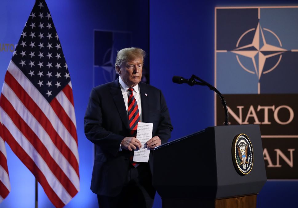 President Donald Trump arrives to speak to the media at a press conference on the second day of the 2018 NATO Summit.