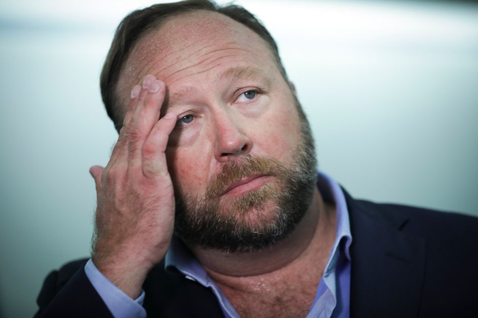 Alex Jones of InfoWars talks to reporters outside a Senate Intelligence Committee hearing.