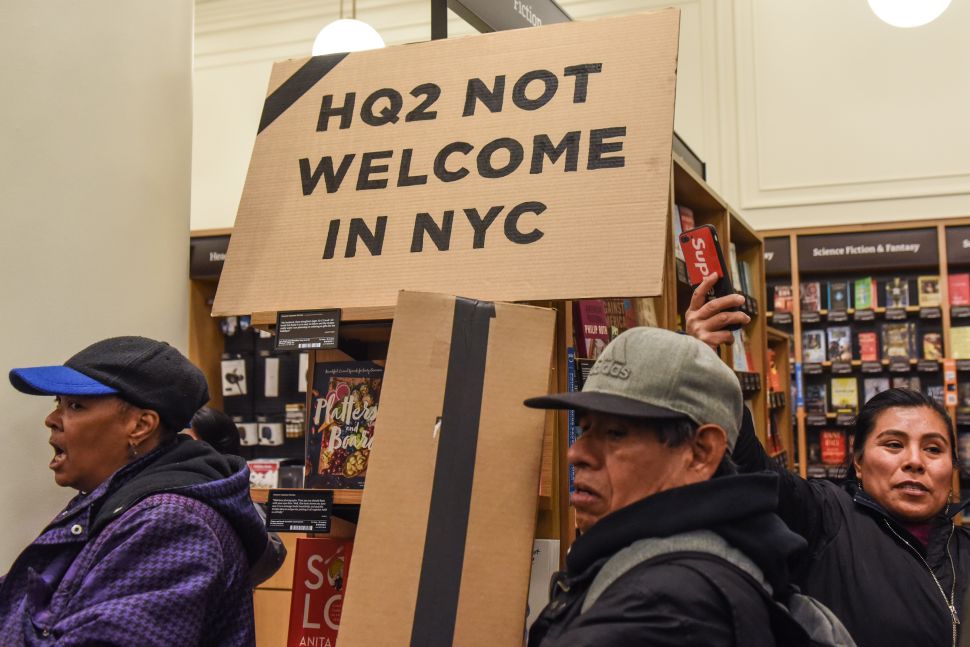 People opposed to Amazon's plan to locate a headquarters in New York City hold a protest inside an Amazon book store on November 26, 2018 in New York City.