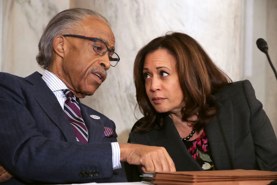 Rev. Al Sharpton (L) talks with Sen. Kamala Harris (D-Calif.) during a post-midterm election meeting.