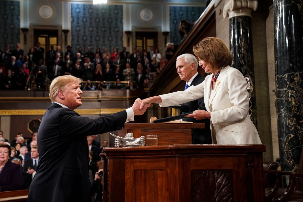 U.S. President Donald Trump shakes hands with Speaker of the House Nancy Pelosi (D-Calif.) while joined by Vice President Mike Pence before delivering the State of the Union address.