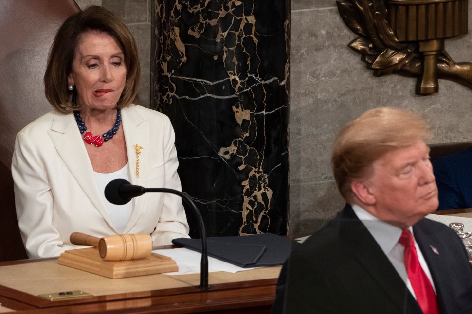 Speaker of the U.S. House of Representatives Nancy Pelosi listens as U.S. President Donald Trump delivers the State of the Union address.
