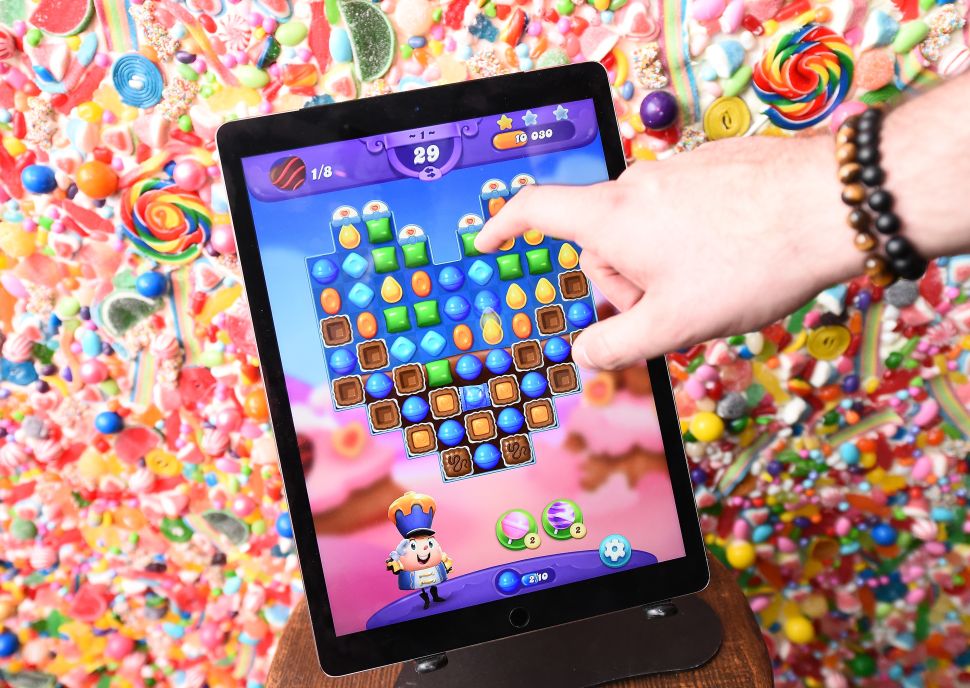 Guest play the new Valentine's Day update in Candy Crush Friends Saga during the "Sweet n Solo" Singles Dining Experience at Dirt Candy on February 6, 2019 in New York City.