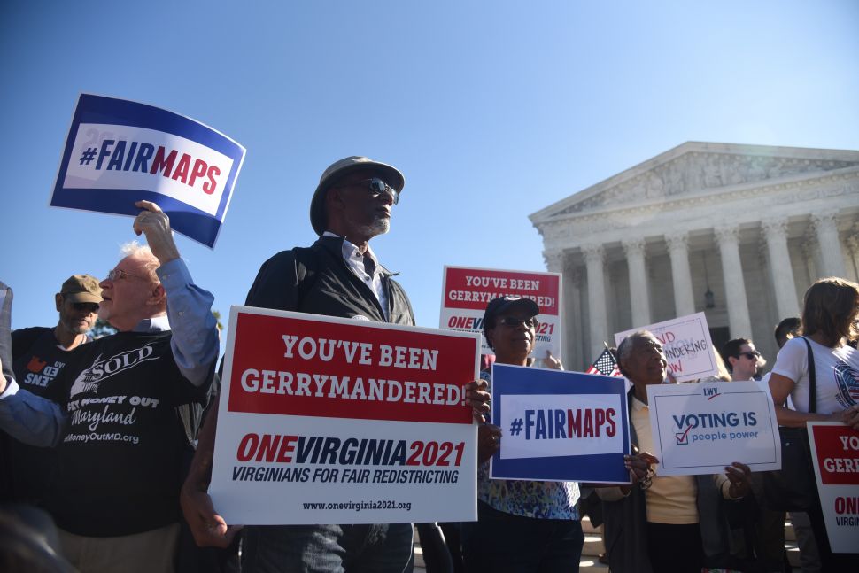 Demonstrators gather outside of the U.S. Supreme Court during oral arguments in Gill v. Whitford to call for an end to partisan gerrymandering on October 3, 2017 in Washington, D.C.