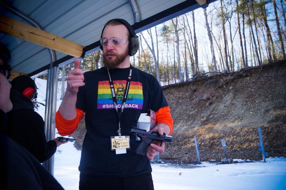 Grossman gives instructions to the, first-timers at the range on how to load bullets into the clip and the proper shooting stance.