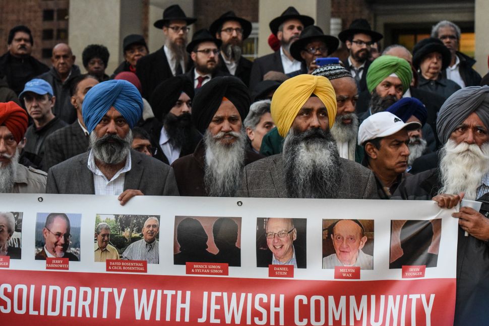 People participate in an interfaith vigil in memory of the victims of the mass shooting at the Tree Of Life Synagogue in Pittsburgh on the steps of Queens Borough Hall on October 29, 2018 in New York City.