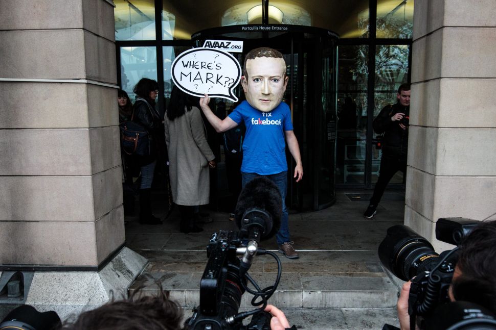 A protester wearing a model head of Facebook CEO Mark Zuckerberg poses for media outside Portcullis House on November 27, 2018 in London, England.