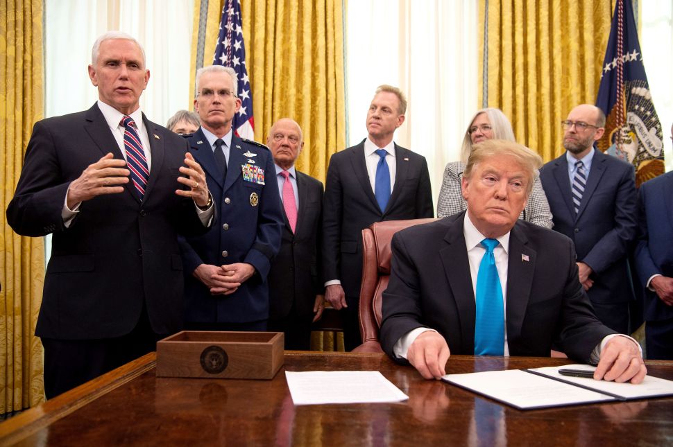 Vice President Mike Pence speaks as President Donald Trump listens.
