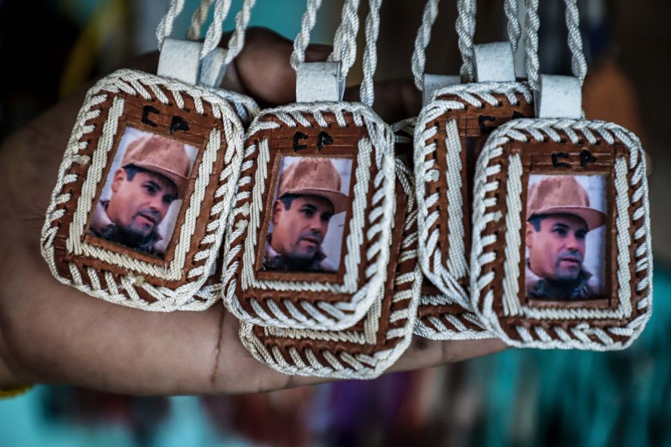 Pendants bearing the image of Mexican drug lord Joaquin "El Chapo" Guzman, are displayed for sale at the narco-saint Jesus Malverde chapel in Culiacan, Sinaloa state in northwest Mexico, on February, 19, 2018.
