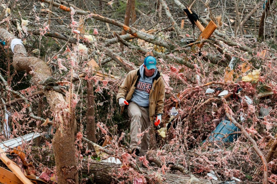 Joey Roush walks through debris on March 4, 2019 at his mother's home after it was destroyed by a tornado in Beauregard, Alabama.