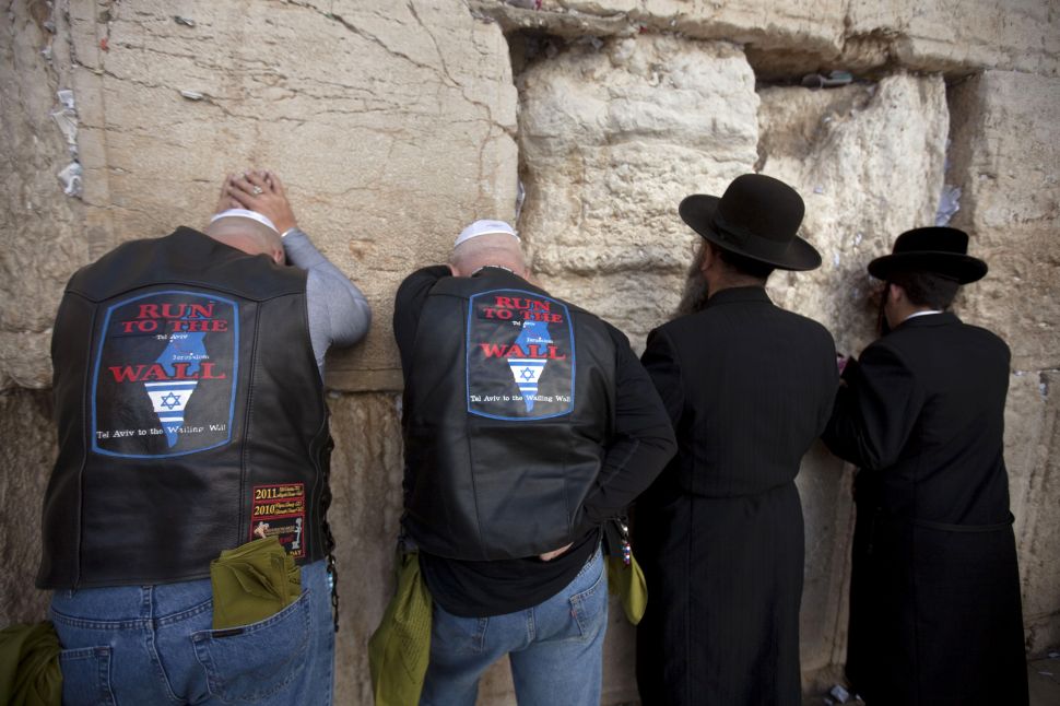 US bikers and supporters of Israel pray next to orthodox Jews at the Western Wall in Jerusalem.