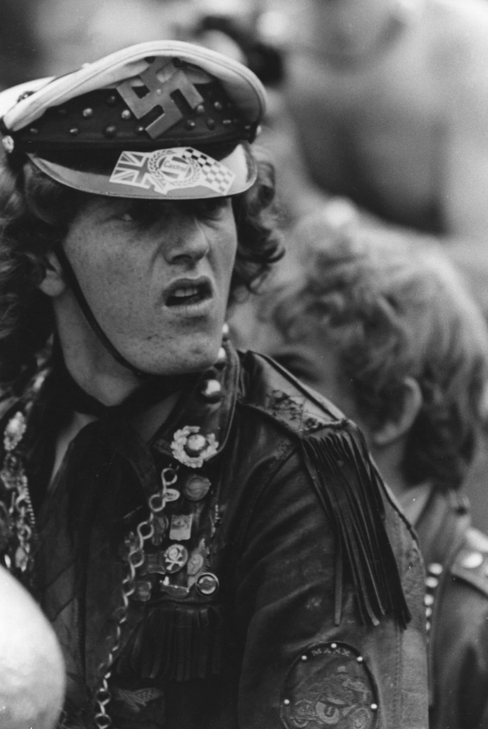 A member of the Hells Angels at a Rolling Stones Concert flaunts a swastika on his cap.