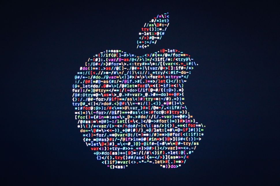 The Apple logo is displayed on a screen at Apple's annual Worldwide Developers Conference on June 13, 2016.