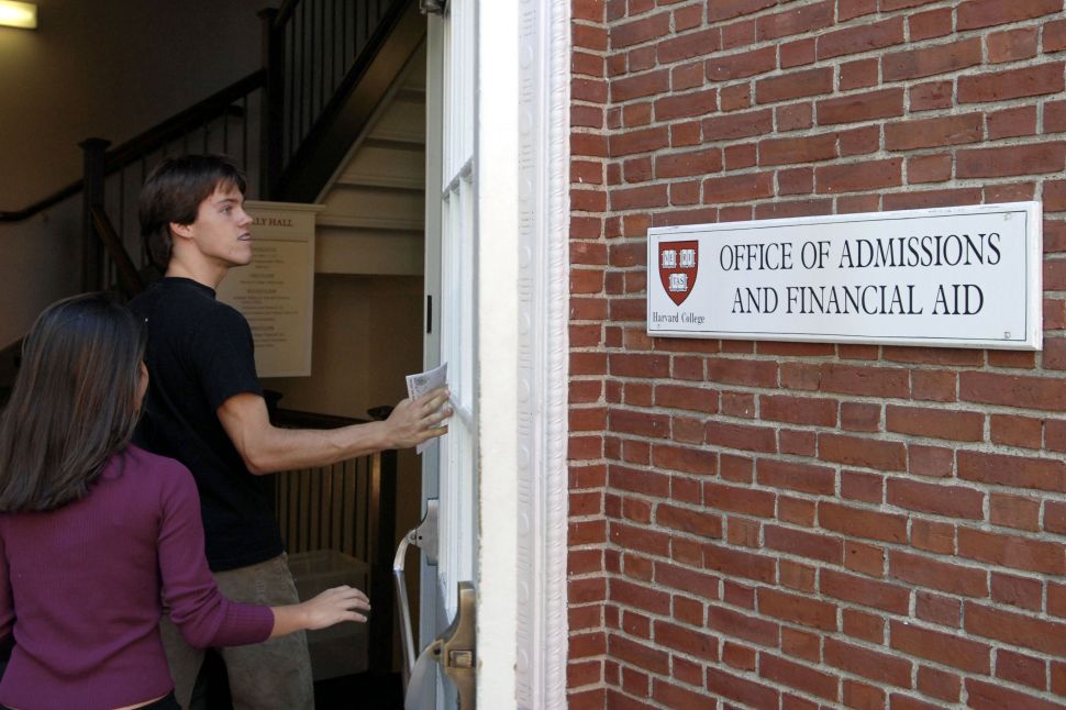 Students enter the Admissions Building on the campus of Harvard University. 