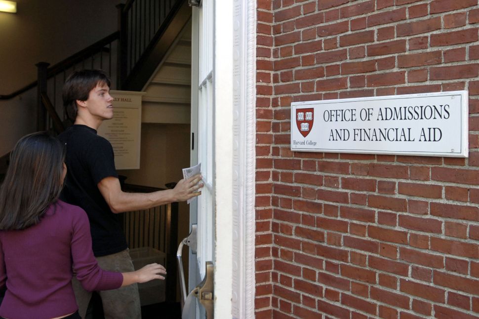 Students enter the Admissions Building on the campus of Harvard University.