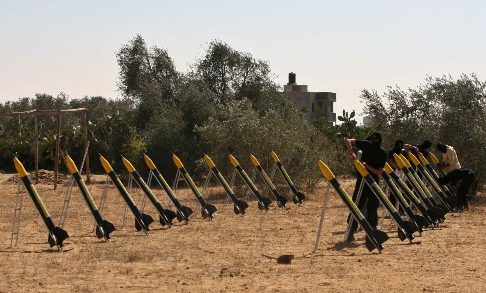 Palestinian militants from the Islamic Jihad's armed wing set-up home-made rockets during training at an undisclosed location in the Gaza Strip on August 13, 2008.