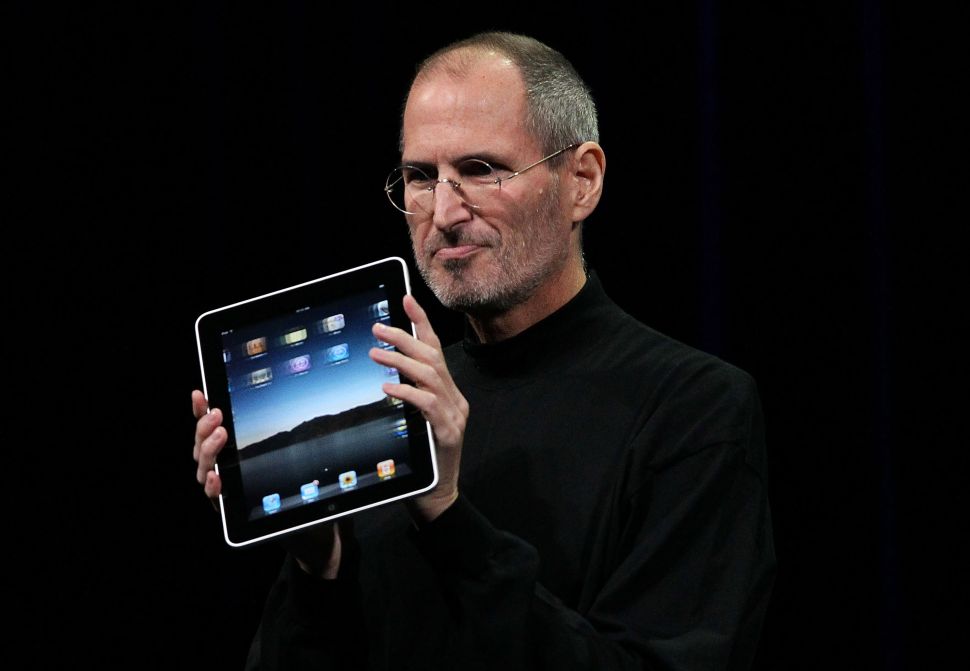 Steve Jobs holds up the first Apple iPad as he speaks during an Apple Special Event on January 27, 2010 in San Francisco, California.