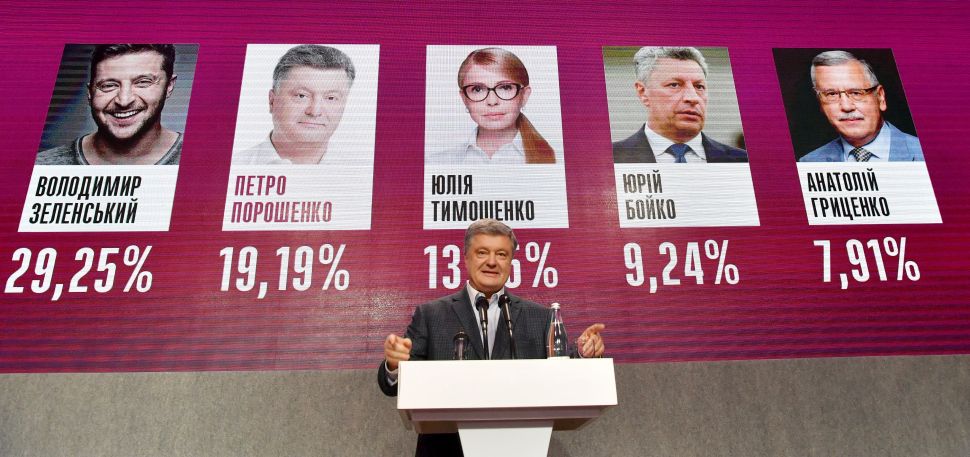 Ukrainian incumbent President Petro Poroshenko delivers a speech in front of a screen displaying exit polls at his campaign headquarters in Kiev, after the first round of Ukraine's presidential election on March 31, 2019.