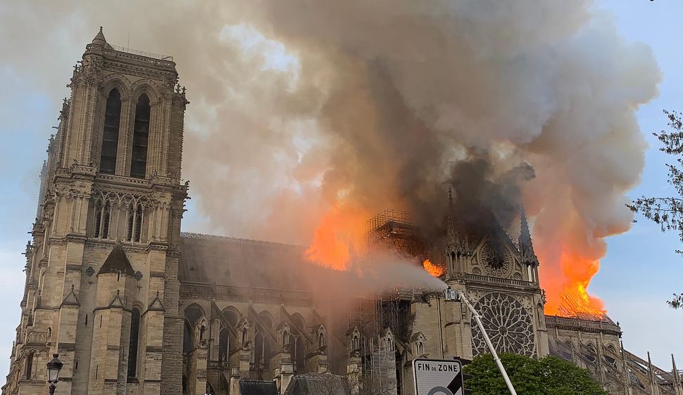 Flames and smoke are seen billowing from the roof at Notre Dame Cathedral in Paris on April 15, 2019.