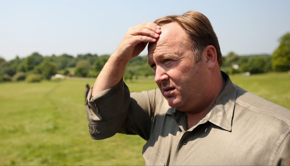 Alex Jones addresses media and protesters in the protester encampment outside The Grove Hotel, which hosted the annual Bilderberg Conference, on June 6, 2013 in Watford, England.