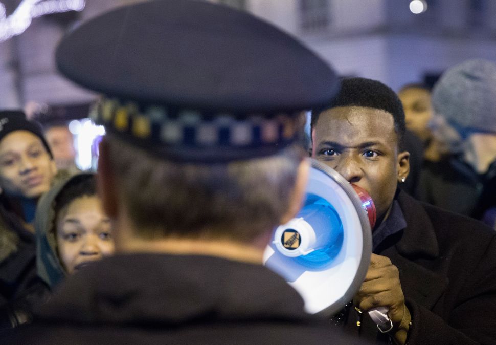 Demonstrators confront police during a protest over the death of Laquan McDonald on November 25, 2015 in Chicago, Illinois.