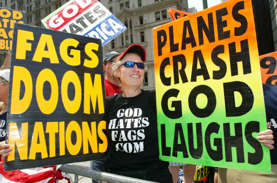 Shirley Phelps holds up signs as she joins fellow members of the Westboro Baptist Church as they protest across the street from Ground Zero on July 4, 2004 in New York City.