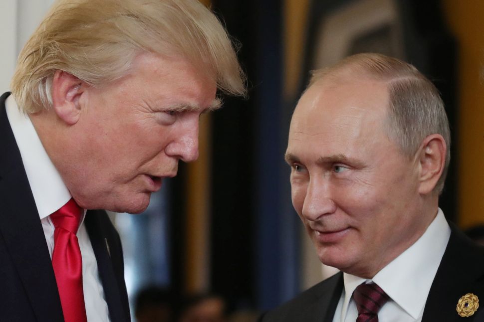 U.S. President Donald Trump (L) chats with Russia's President Vladimir Putin (R).