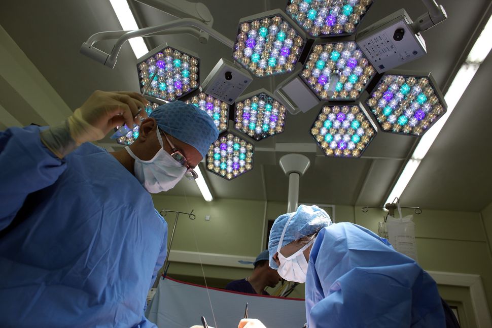 A surgeon and his team perform surgery