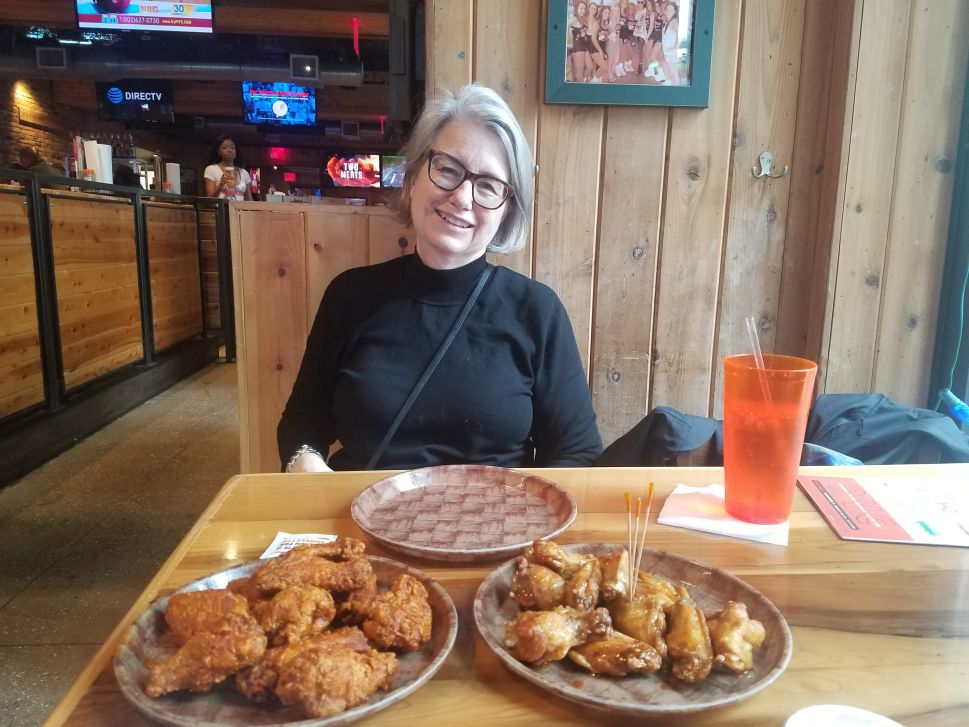 The author's mother enjoying wings with her son at Hooters on Mother's Day.