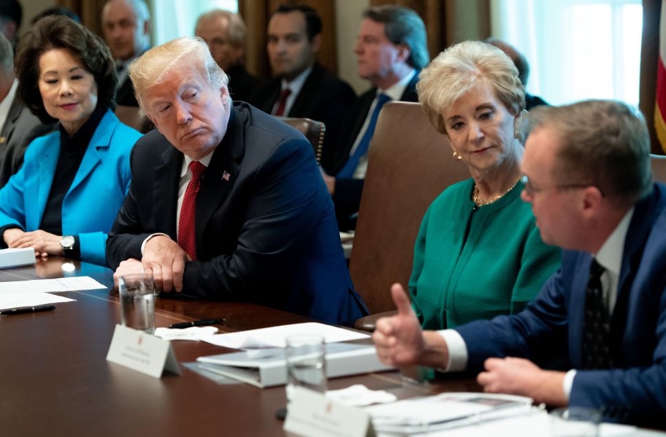 President Donald Trump looks to Mick Mulvaney.