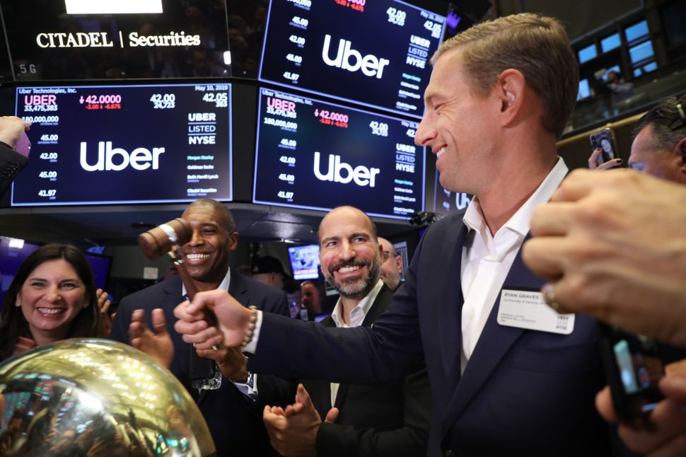 Uber CEO Dara Khosrowshahi (center) rings a ceremonial bell signifying the first trade of Uber on May 10, 2019 in New York City.