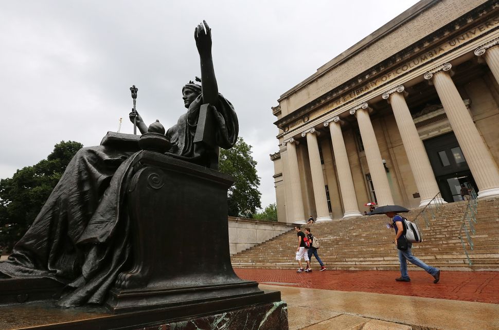 People walk past the Alma Mater statue on the Columbia University campus in New York City. 