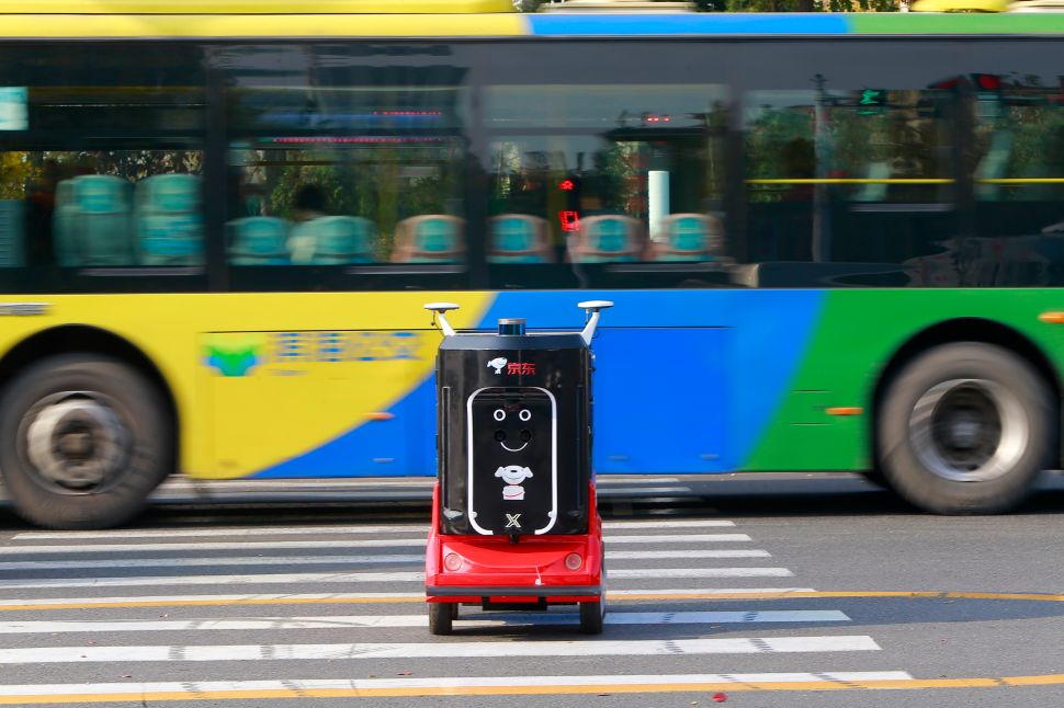 A JD.com unmanned delivery robot is seen crossing a street on November 12, 2018 in Tianjin, China. 