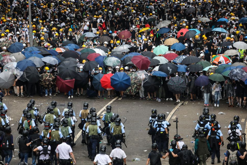Protesters face off with police during a rally against a controversial extradition law proposal outside government headquarters in Hong Kong on June 12, 2019.