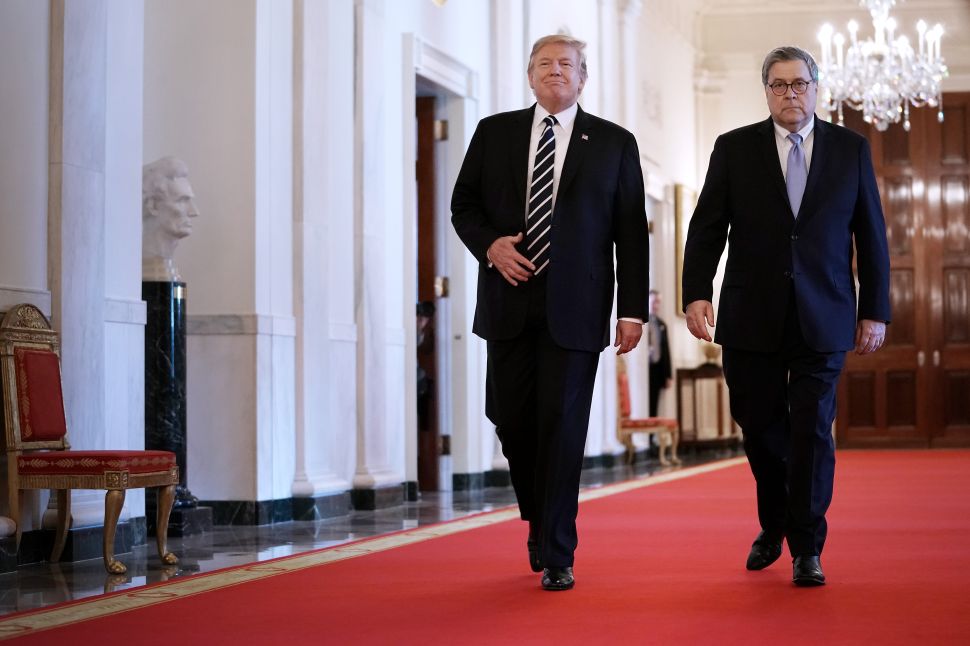 U.S. President Donald Trump (L) and Attorney General William Barr