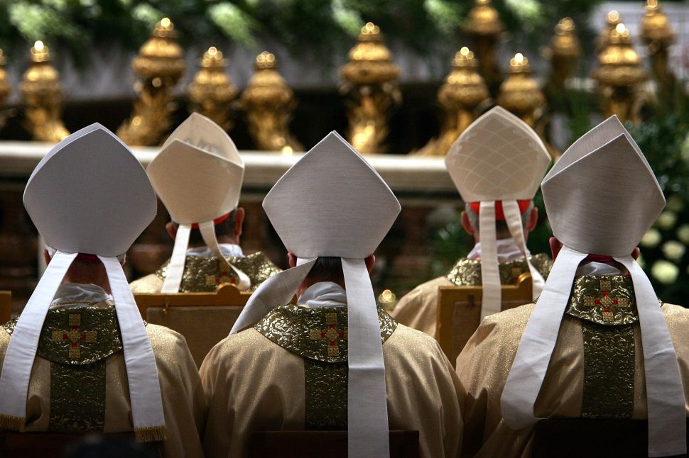 Cardinals face the altar as Colombian Cardinal Alfonso Lopez Trujillo gives the Mass of The Lords Supper in St Peter's Basilica on March 24, 2005 in Vatican City.