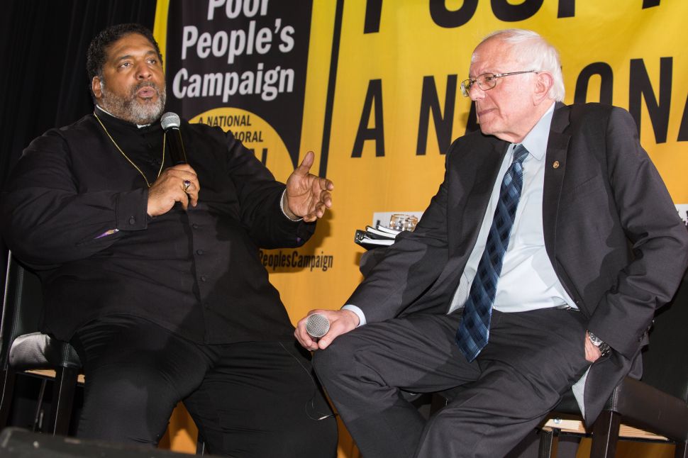 Bernie Sanders speaks with Rev. William Barber at the Poor People's Moral Action Congress at Trinity University in Washington D.C.