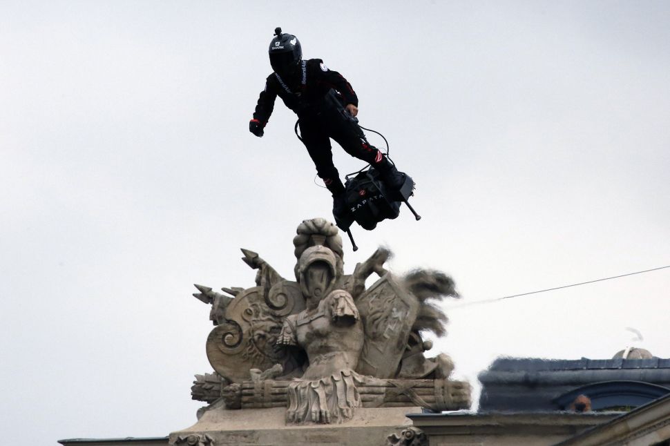 Franky Zapata, a French inventor and entrepreneur, flies a jet-powered hoverboard during the annual Bastille Day military parade in Paris, France on July 14, 2019.