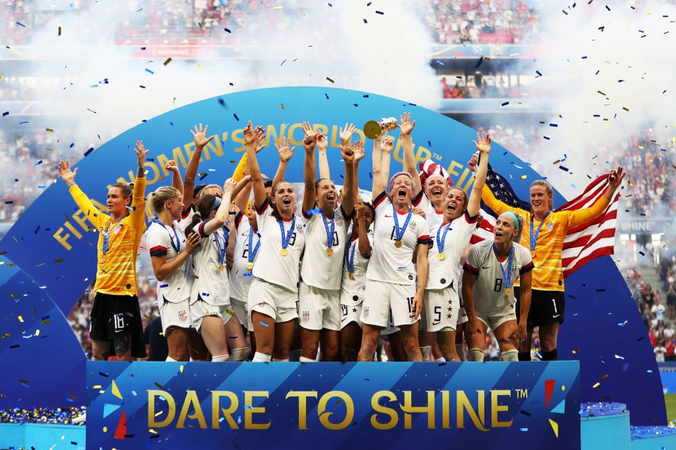 Megan Rapinoe of the USA lifts the FIFA Women's World Cup trophy on July 7, 2019 in Lyon, France.