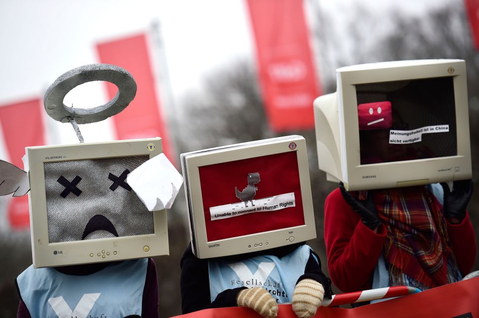 Protesters against internet censorship, wearing computers as helmets, are seen on March 15, 2015 in Hanover, Germany.