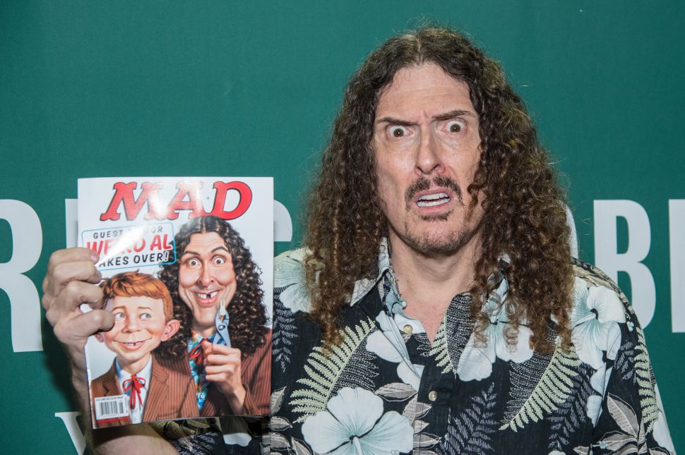 Singer Weird Al Yankovic signs copies of Mad magazine's issue #533 at Barnes & Noble Union Square on April 20, 2015 in New York City. 